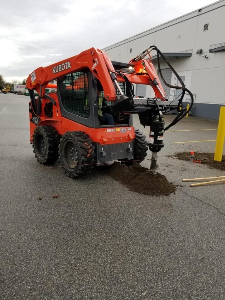 Hydraulic auger preparing post holes; LS project in the Fraser Valley.